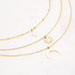 Mathilde & Filles | Collier trois chaines embelli de pendentifs astrologiques comme une étoile un croissant de lune et une pièce martelée