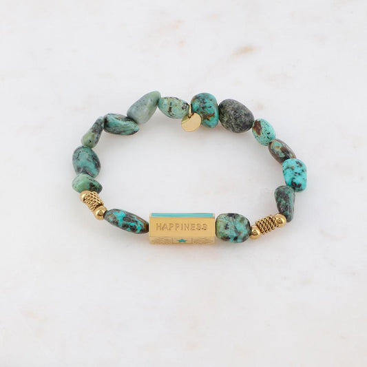 Bracelet élastique orné de pierres naturelle turquoise africaine et embelli d'un cylindre de couleur dorée et turquoise | Mathilde & Filles